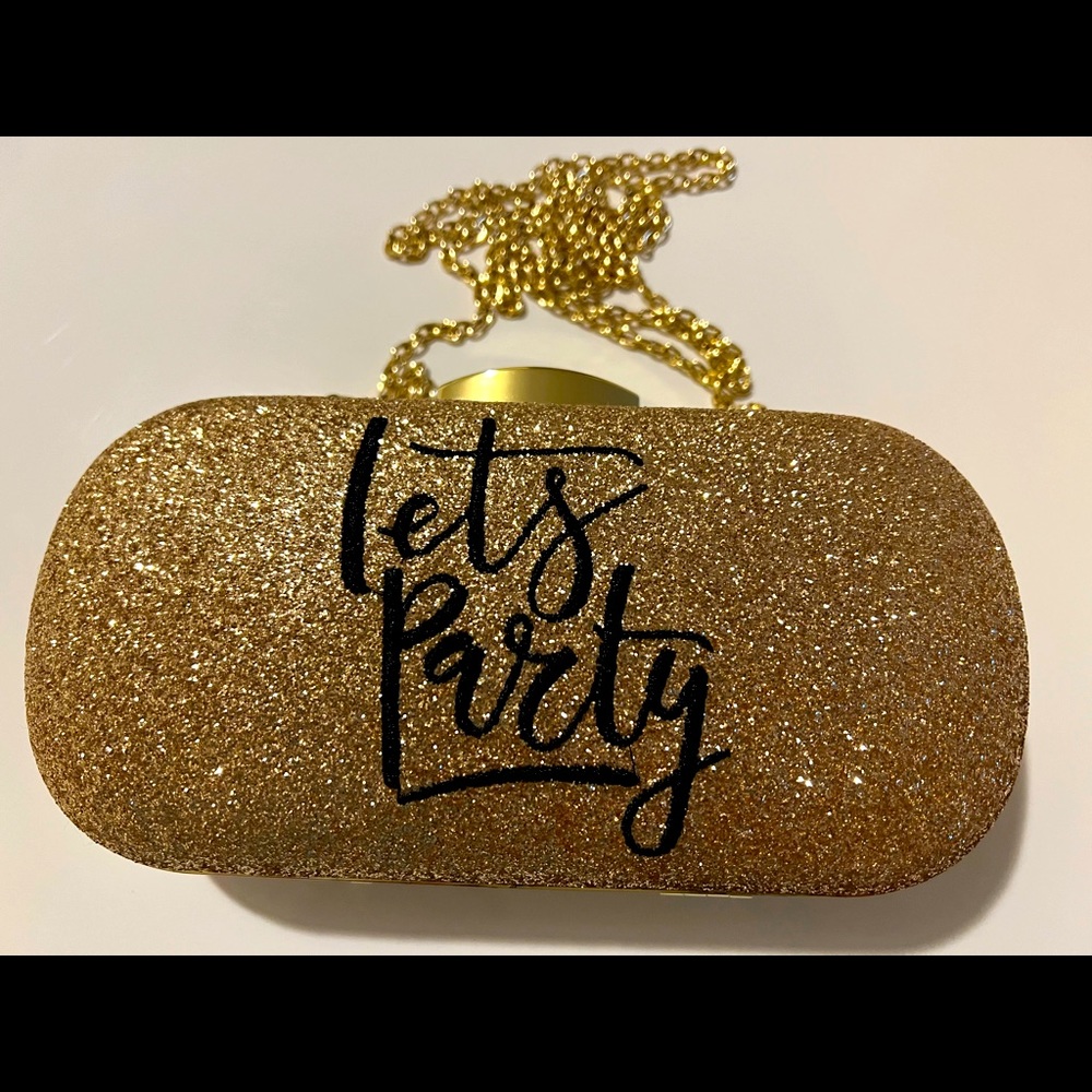 Never worn, Gold charming Charlie Clutch Purse. Snap closure.